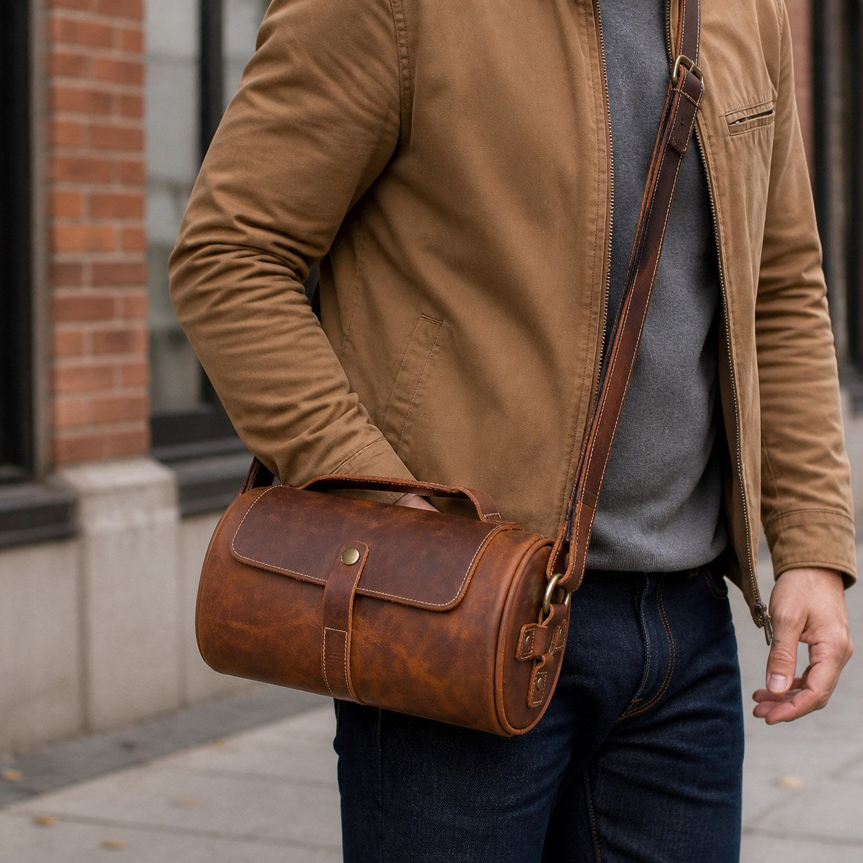 Brown Crazy Horse leather barrel bag worn crossbody on a city commute