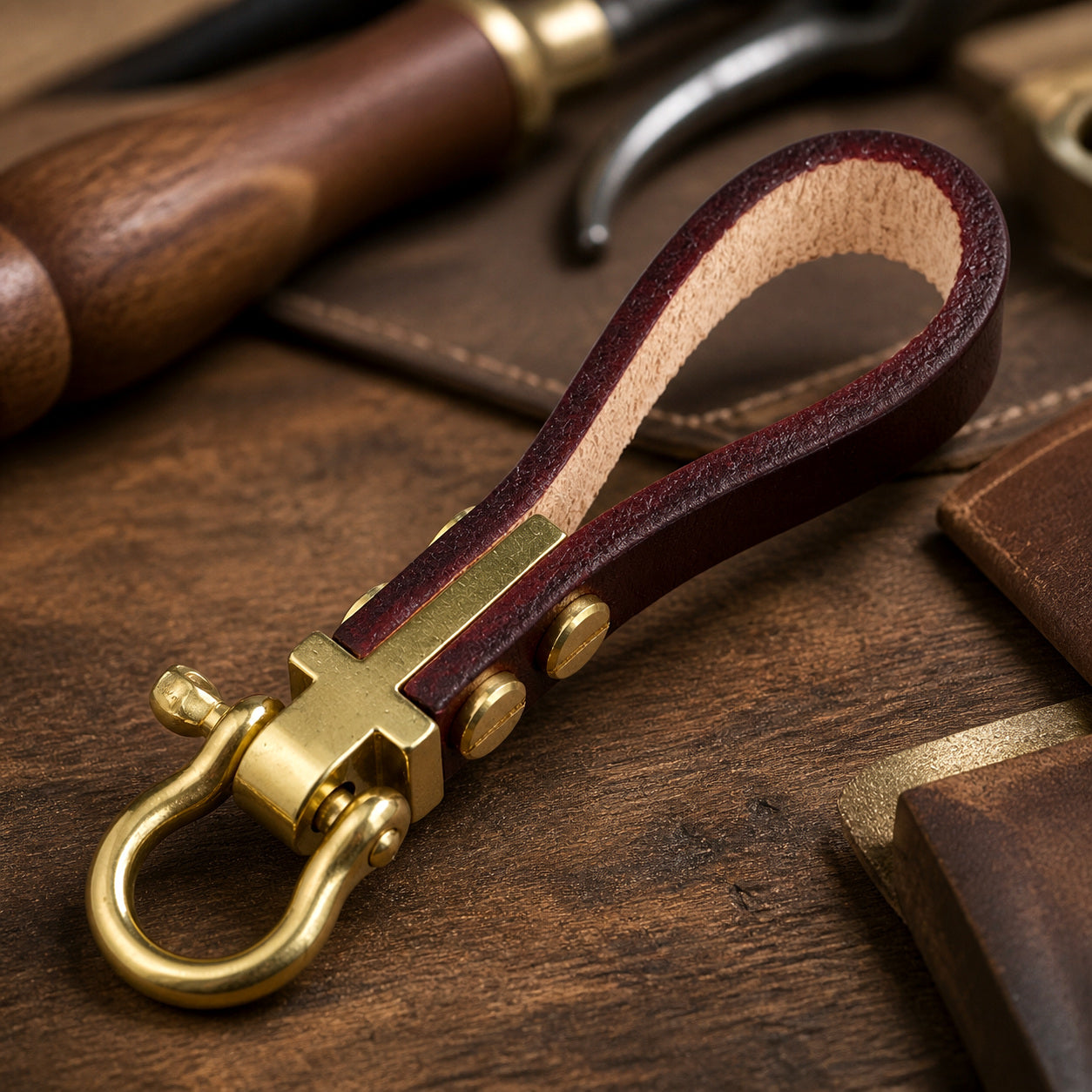 Close-up of brass horseshoe shackle keychain hardware rivets and leather loop